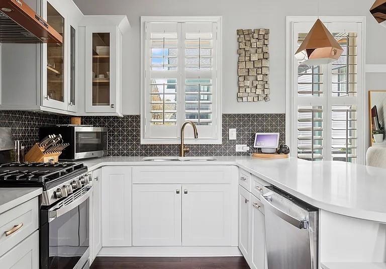 1905 Galt Cmns Kennesaw, GA 30144 - Photo 6 of 28 a kitchen with granite countertop a sink a stove and cabinets