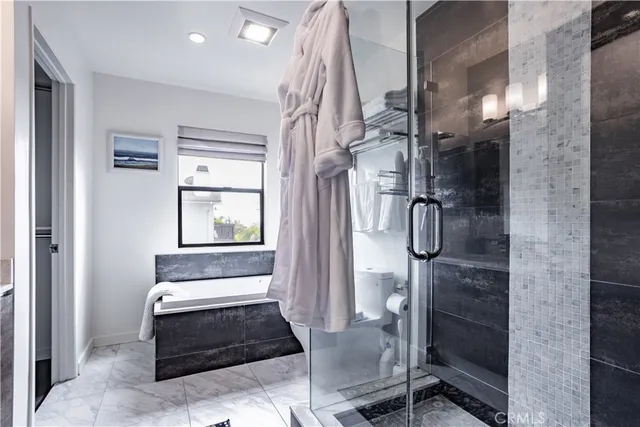 a bathroom with a bathtub and shower