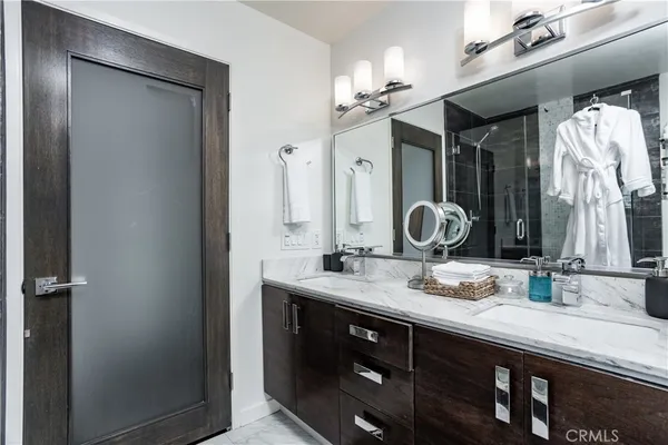 a bathroom with a double vanity sink and a mirror