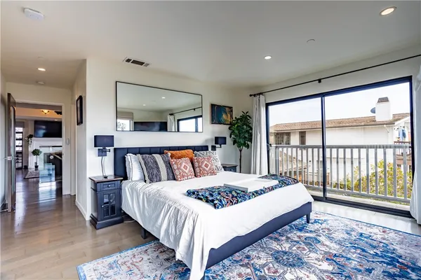 a large bedroom with a large bed and a large window
