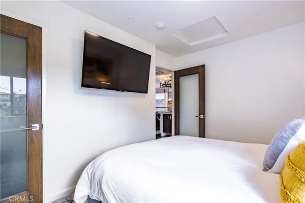 a bedroom with a bed and a flat screen tv