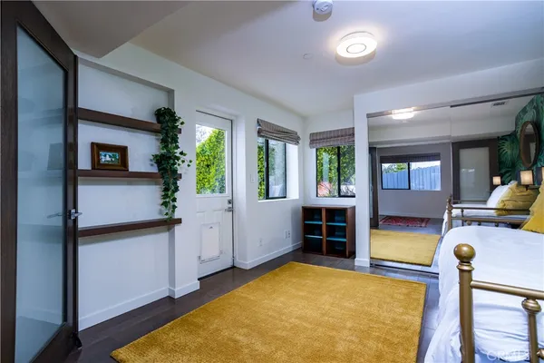 a bedroom with furniture and a wooden floor
