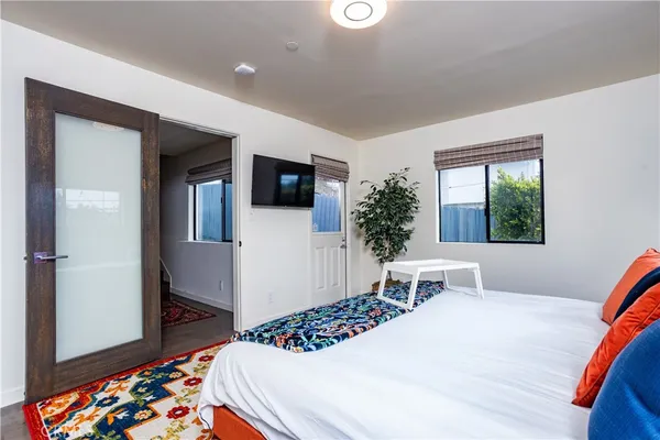 a bedroom with a bed and a flat screen tv