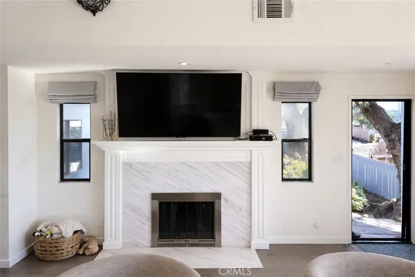 a living room with a fireplace and a flat screen tv