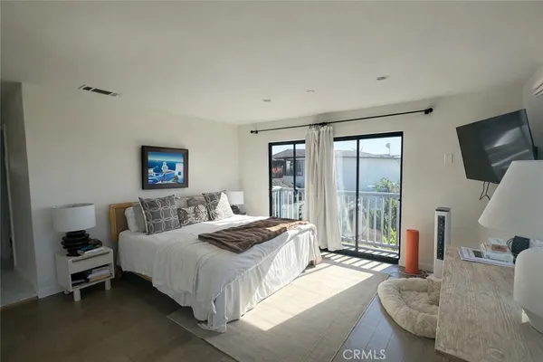 a spacious bedroom with a bed and large windows