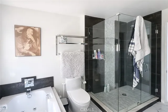 a bathroom with a shower a toilet and a sink