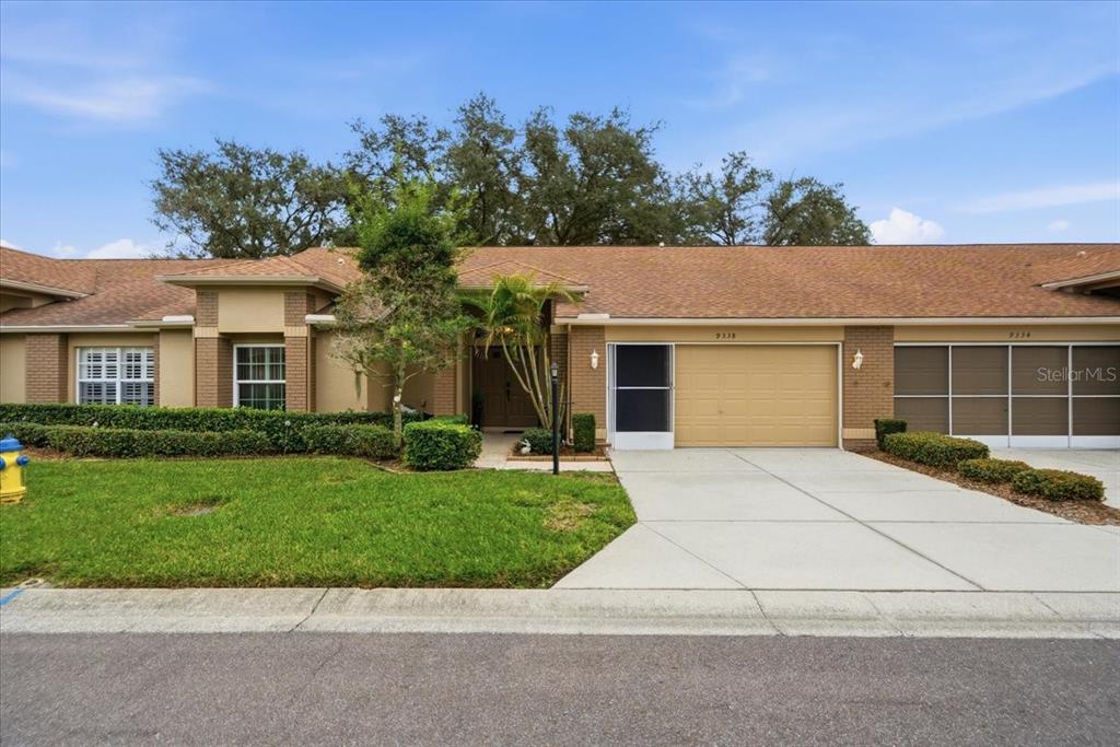 9338 Clearmeadow New Port Richey, FL 34655 - Photo 1 of 54 a front view of a house with a yard and potted plants