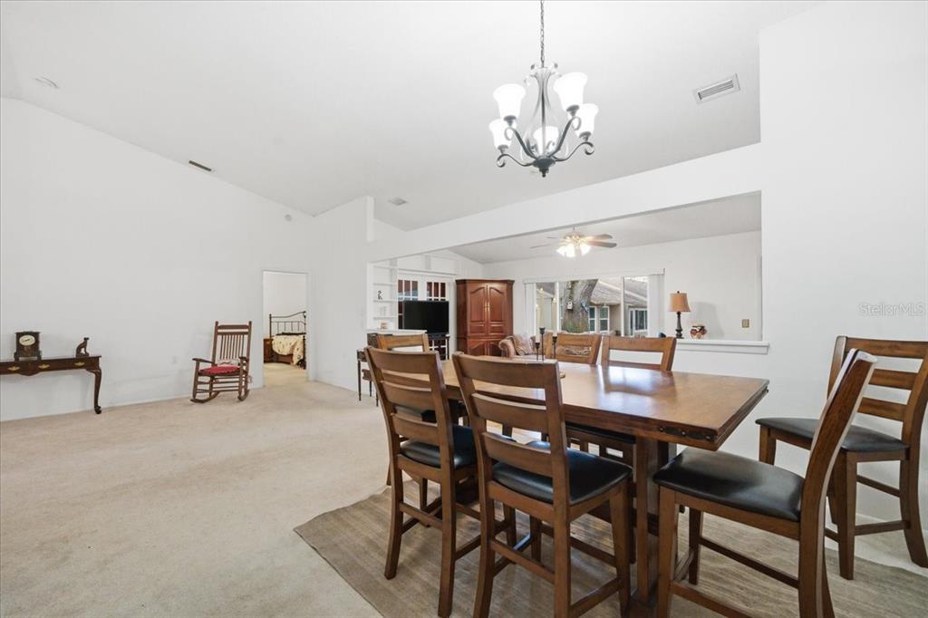 9338 Clearmeadow New Port Richey, FL 34655 - Photo 11 of 54 a view of a dining room with furniture and chandelier