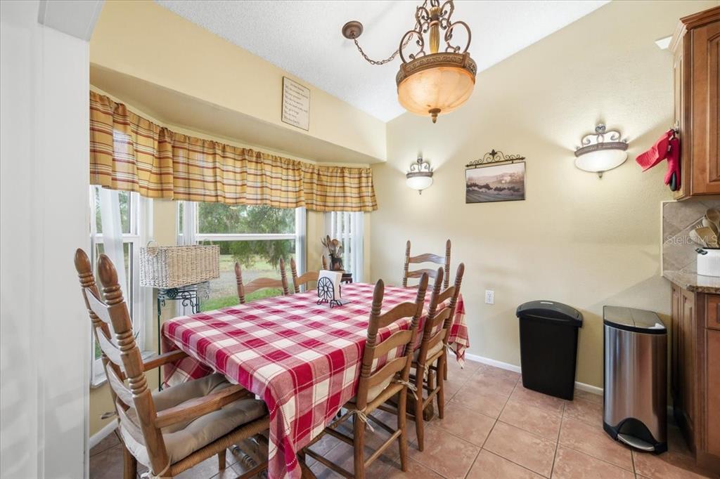 9338 Clearmeadow New Port Richey, FL 34655 - Photo 18 of 54 a dining room with furniture and window