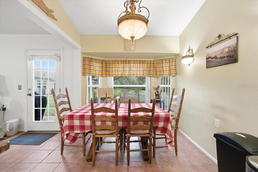 9338 Clearmeadow New Port Richey, FL 34655 - Photo 19 of 54 a dining room with furniture and window