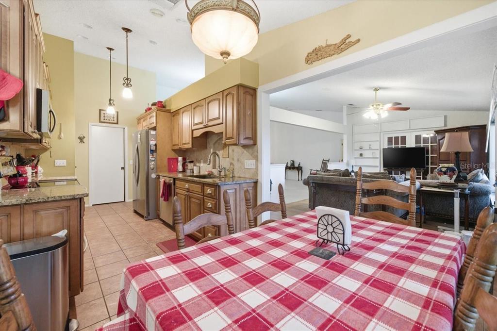 9338 Clearmeadow New Port Richey, FL 34655 - Photo 20 of 54 a open kitchen with stainless steel appliances granite countertop a sink dishwasher stove top oven and cabinets