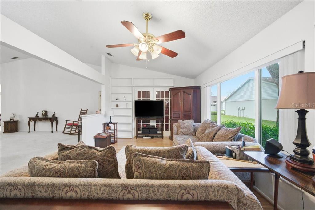 9338 Clearmeadow New Port Richey, FL 34655 - Photo 23 of 54 a living room with furniture a flat screen tv and a large window
