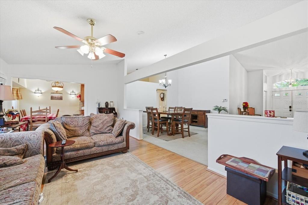 9338 Clearmeadow New Port Richey, FL 34655 - Photo 26 of 54 a living room with furniture kitchen view and a chandelier