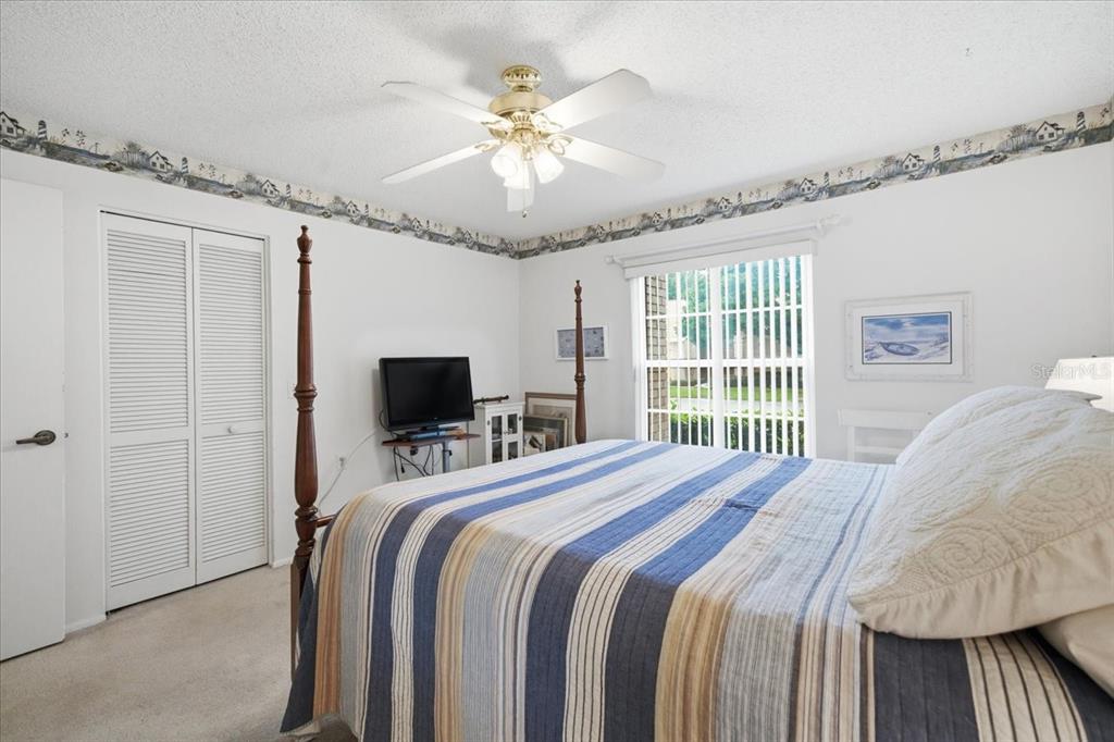 9338 Clearmeadow New Port Richey, FL 34655 - Photo 28 of 54 a bedroom with a bed and a ceiling fan