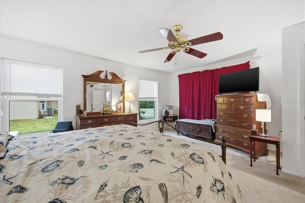 9338 Clearmeadow New Port Richey, FL 34655 - Photo 31 of 54 a bedroom with a bed and a television