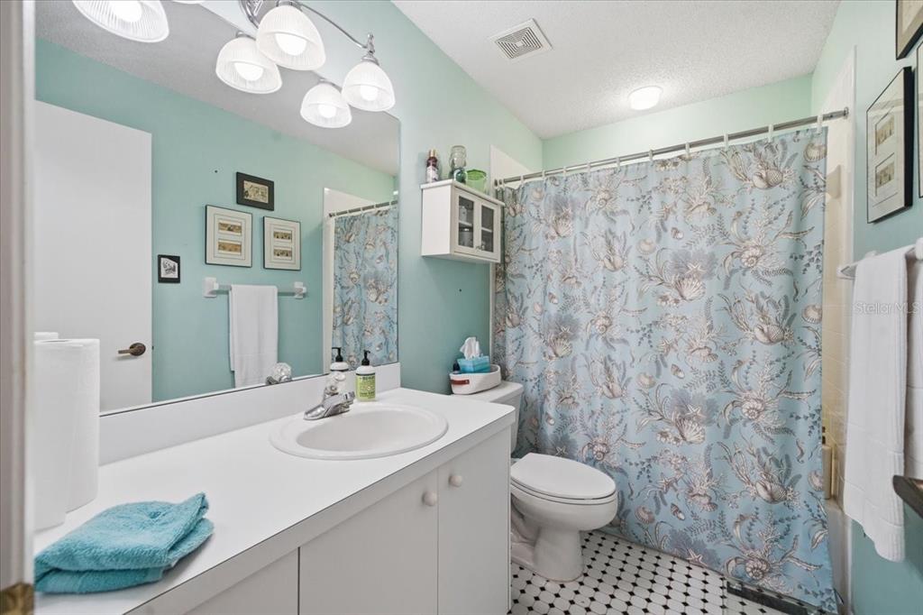 9338 Clearmeadow New Port Richey, FL 34655 - Photo 32 of 54 a bathroom with a sink a toilet and shower