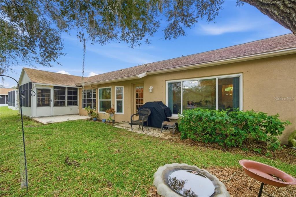 9338 Clearmeadow New Port Richey, FL 34655 - Photo 38 of 54 a view of a house with backyard sitting area and garden