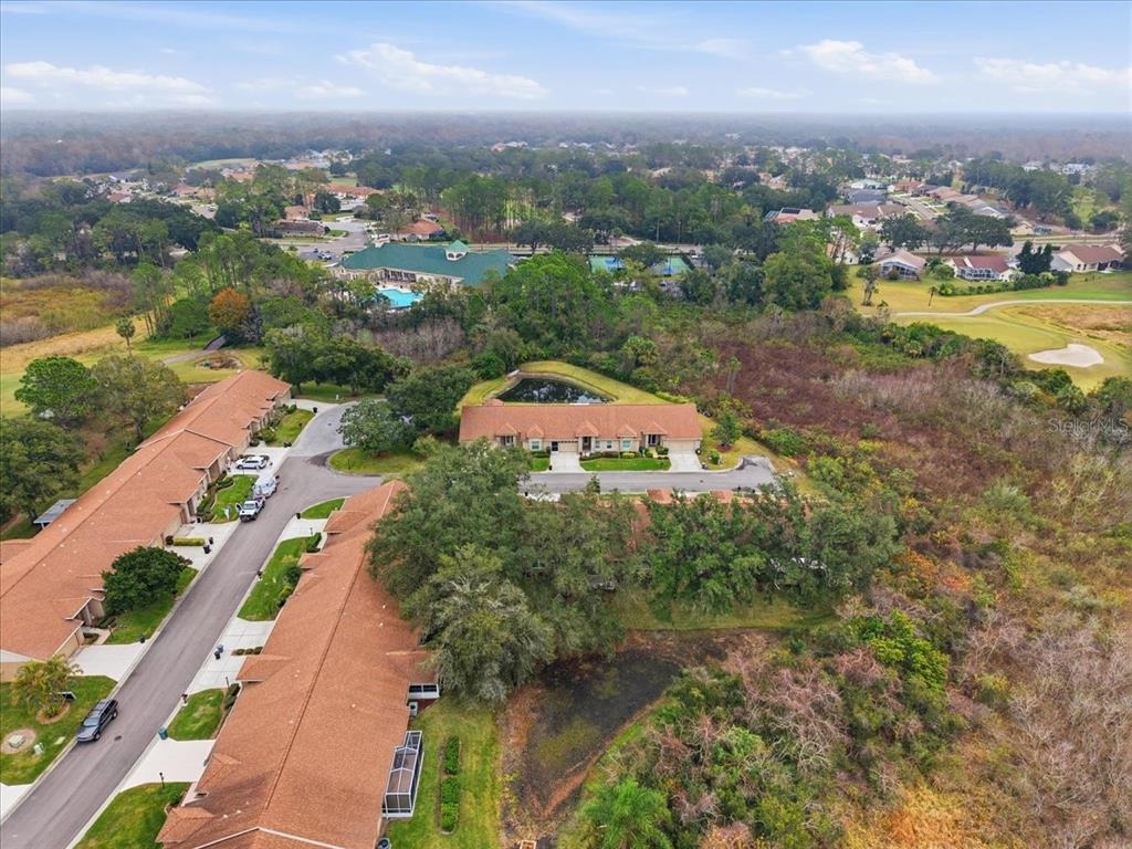 9338 Clearmeadow New Port Richey, FL 34655 - Photo 48 of 54 an aerial view of a house with a garden and lake view