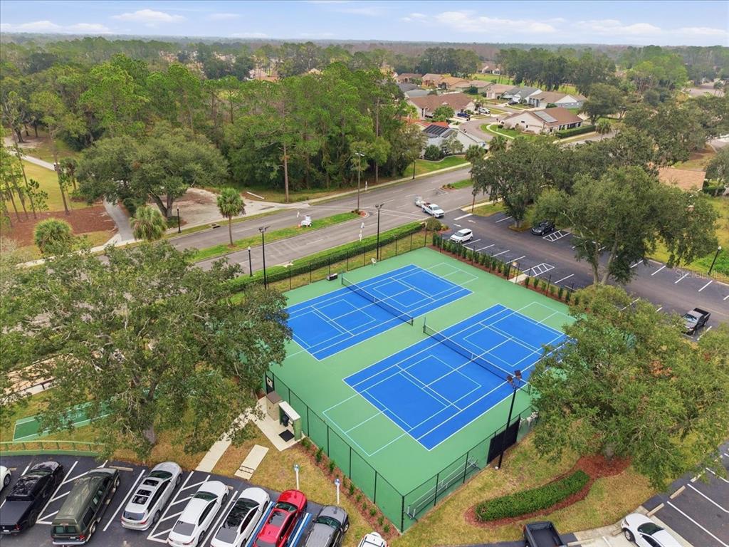 9338 Clearmeadow New Port Richey, FL 34655 - Photo 50 of 54 an aerial view of a tennis ground and a yard in the back