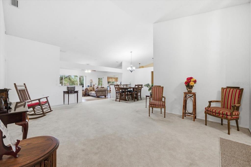 9338 Clearmeadow New Port Richey, FL 34655 - Photo 7 of 54 a living room with furniture and a flat screen tv