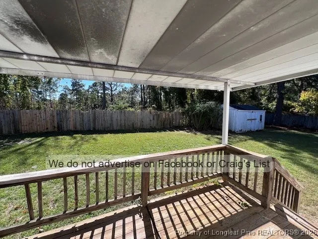 a view of backyard with deck and garden