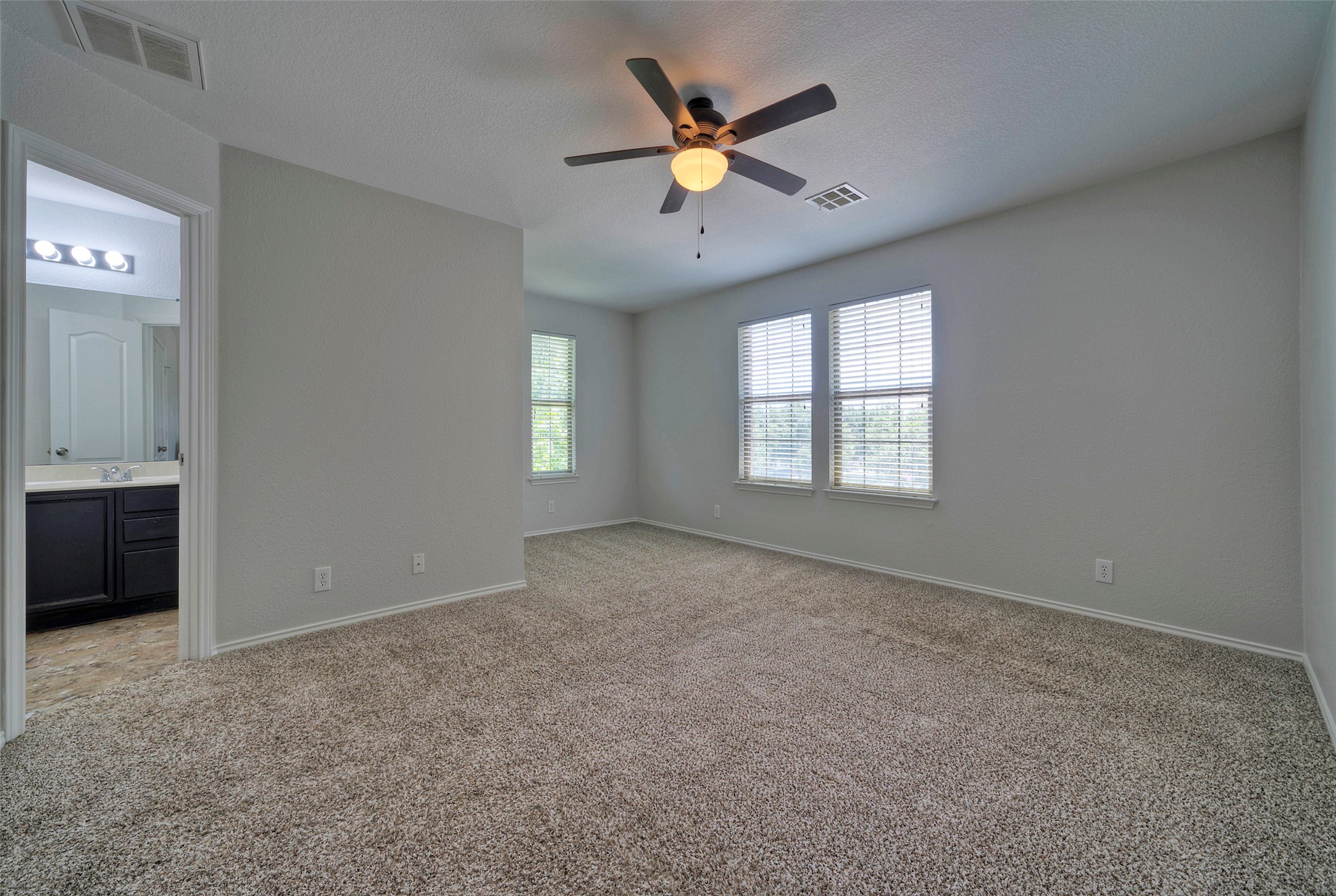 140 Plum Path Kyle, TX 78640 - Photo 7 of 22 an empty room with windows and ceiling fan