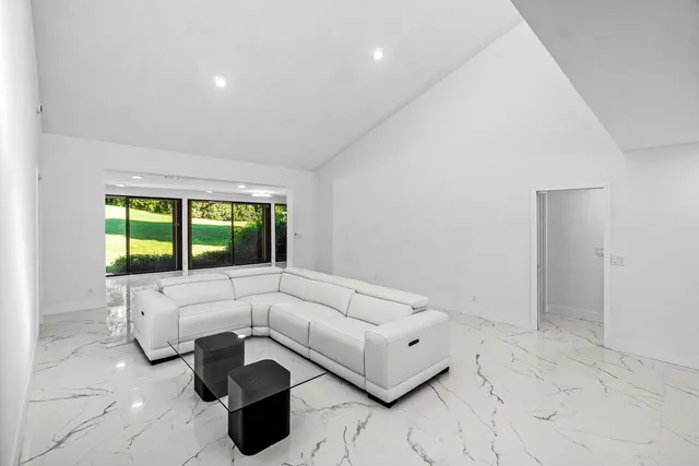 a bathroom with sinks a vanity a lamp and a large window