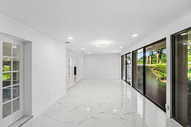 a living room with furniture a flat screen tv and a table