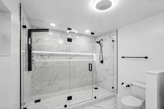 a living room filled with furniture and a large window