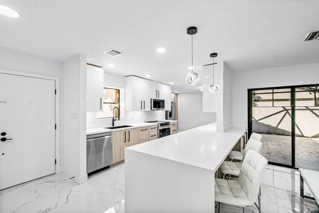 a spacious bedroom with a bed and a large window