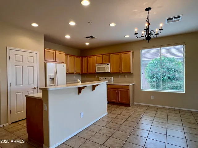 a kitchen with a stove sink and cabinets