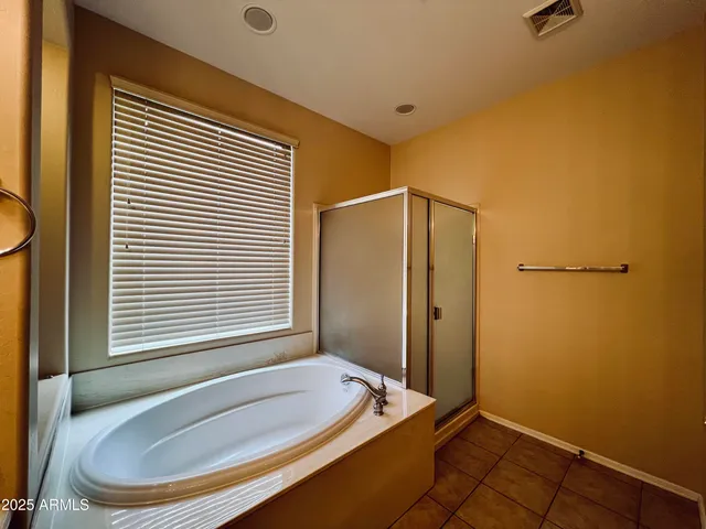 a bathroom with a tub and a window