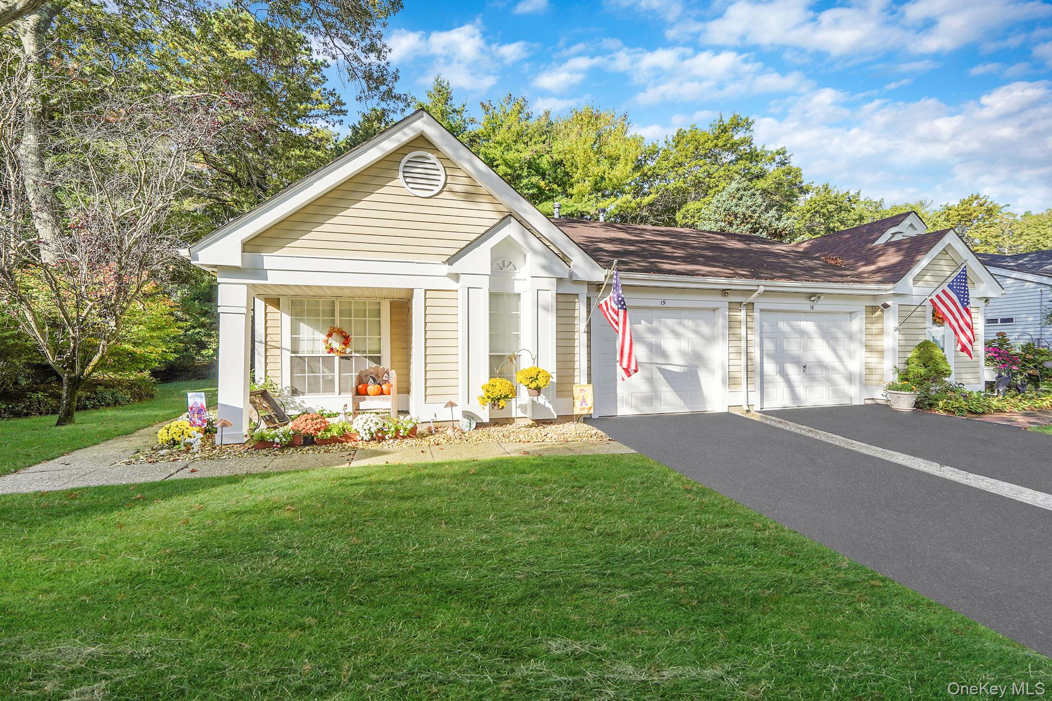 19 Villanova Court Ridge, NY 11961 - Photo 1 of 1 View of front of home featuring driveway, a porch, a front yard, and a garage
