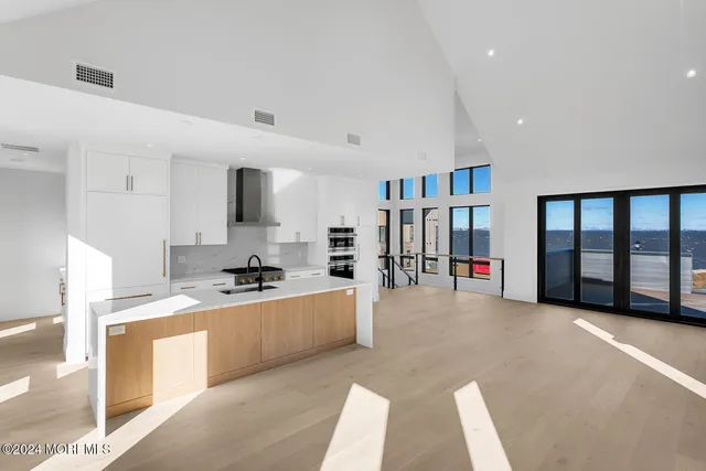 a view of a kitchen with a sink and a refrigerator