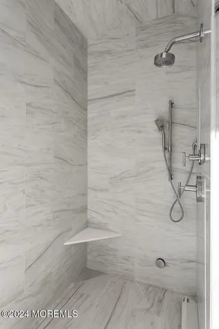 a bathroom with a sink mirror and a toilet