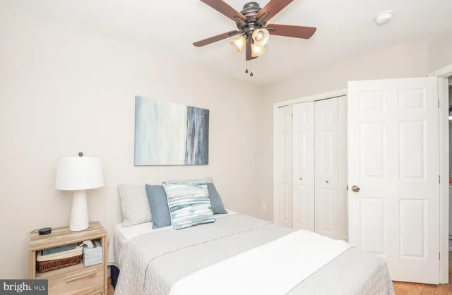a bedroom with a bed and a lamp on table