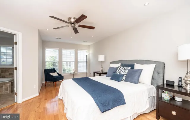 a bedroom with a large bed and a large window