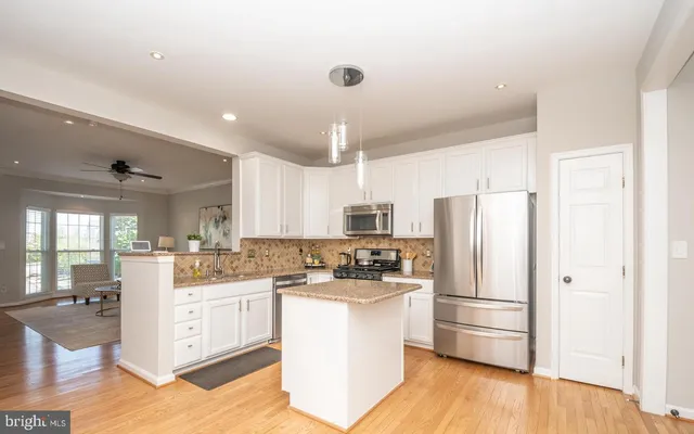 a kitchen with a refrigerator sink and cabinets