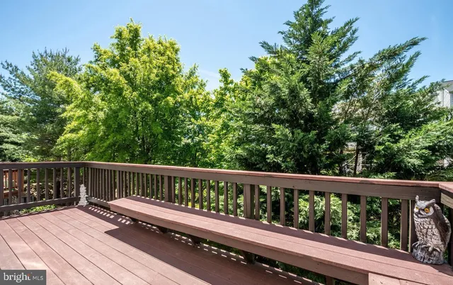 a view of balcony with wooden floor and fence