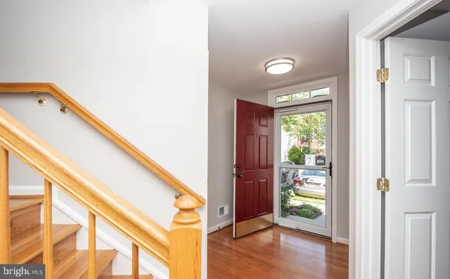 a view of hallway with furniture and a gate