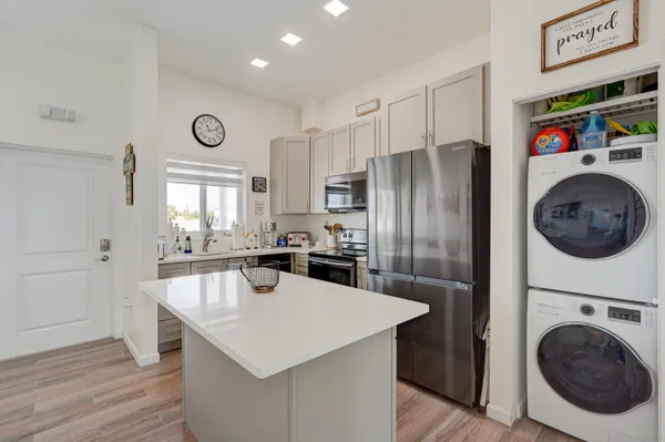a kitchen with kitchen island a sink a stove and refrigerator