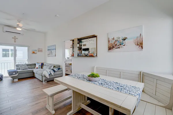 a view of a dining room with furniture wooden floor and a chandelier
