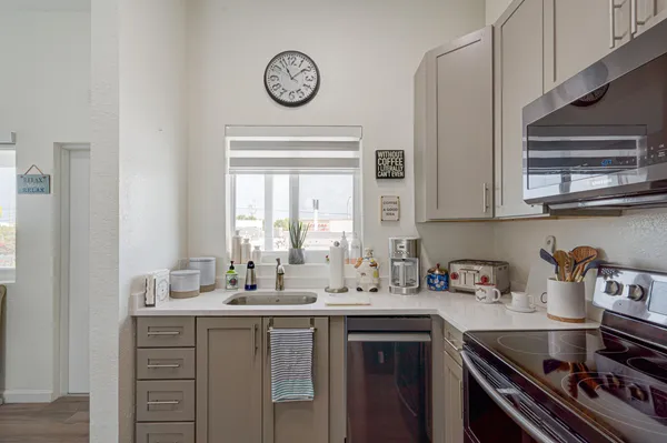 a kitchen with a sink cabinets and a window