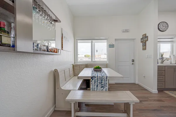 a view of a dining room with furniture and wooden floor