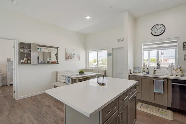a kitchen with a table chairs and white cabinets
