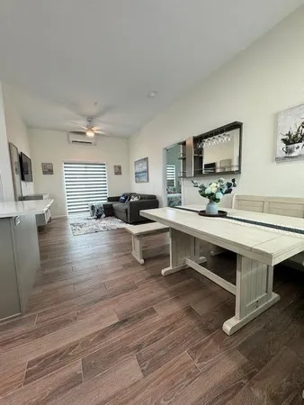 a living room with furniture flat screen tv and window