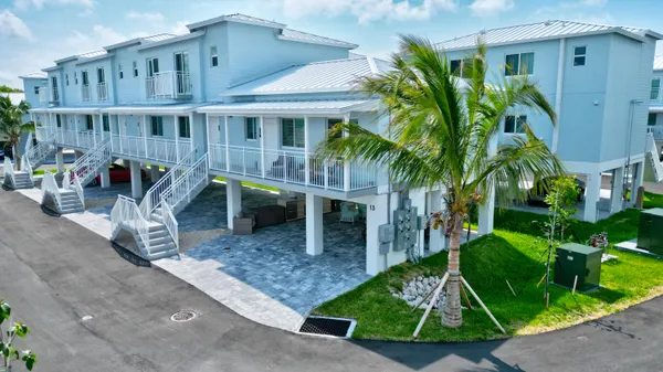 a backyard of a house with barbeque oven and plants