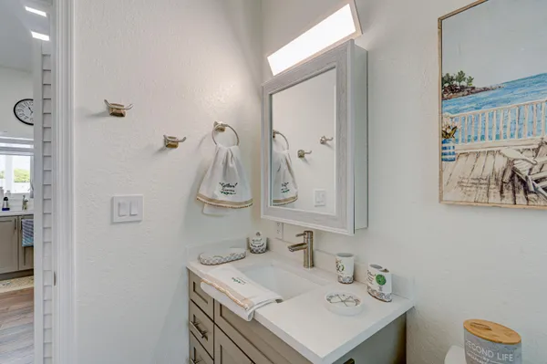 a bathroom with a sink vanity and mirror