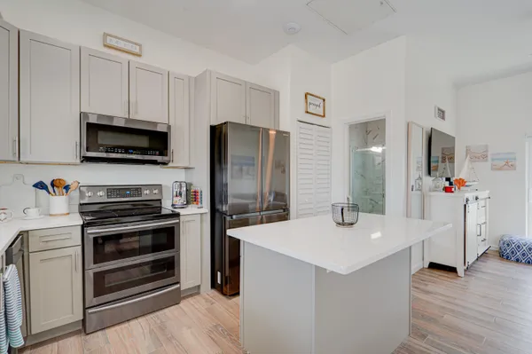 a kitchen with stainless steel appliances a stove refrigerator sink and microwave