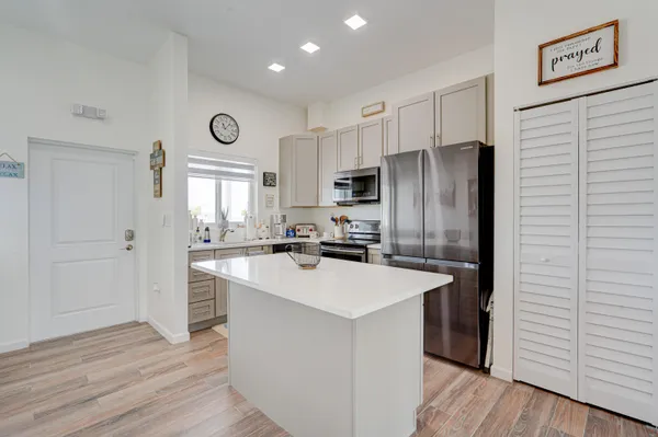 a kitchen with appliances a sink and a refrigerator